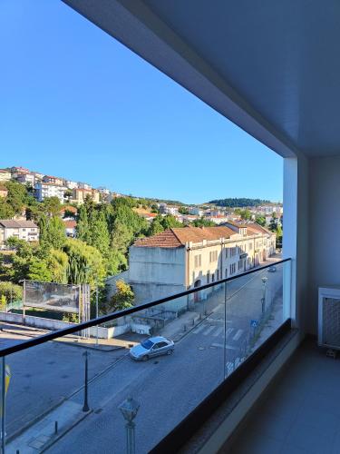 a room with a large window with a view of a street at Loreto House in Bragança
