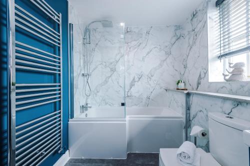 a white bathroom with a tub and a sink at NEW! Stunning 3-Bed Home in Chester by 53 Degrees Property, Ideal for Groups, FREE Parking! in Chester