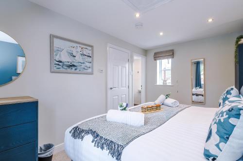 a bedroom with a white bed with a blue dresser at NEW! Stunning 3-Bed Home in Chester by 53 Degrees Property, Ideal for Groups, FREE Parking! in Chester