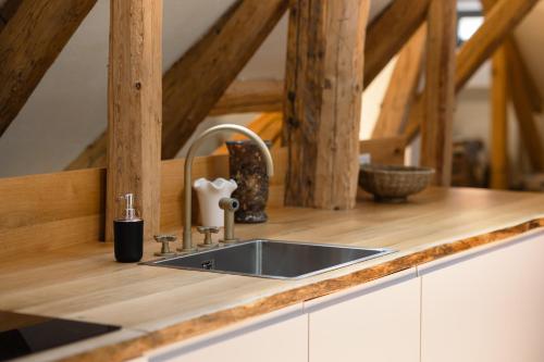 a kitchen with a sink and a wooden counter top at House 66 in Braşov