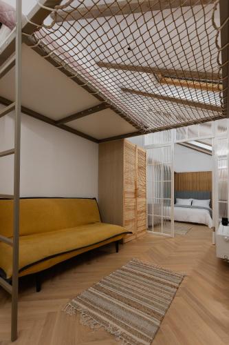 a bedroom with a couch and a bed in it at House 66 in Braşov