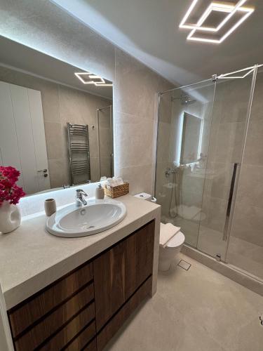a bathroom with a sink and a shower at Paros Relux in Kampos Paros