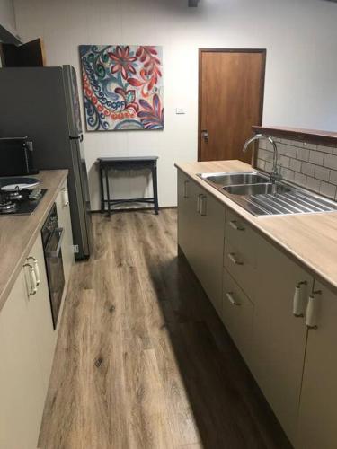 a kitchen with a sink and a counter top at Snow Chalet Off Mountain in Goughs Bay