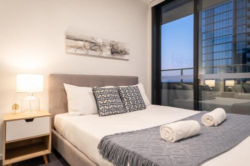 a bedroom with a bed and a large window at Footscray pool pleasant &Bright 2BR2BA apt in Melbourne