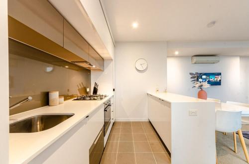 a kitchen with a sink and a counter top at Luxury living on top floors 3 Bedroom Mel CBD Pool in Melbourne