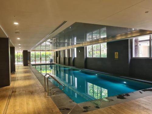 a swimming pool with blue water in a building at Brand new 2BR2BA Caulfield parkbalcony poolgym in Melbourne