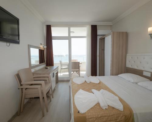 a hotel room with a bed with towels on it at Seymen Otel in Kizkalesi