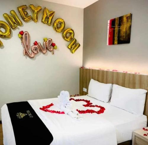 a bedroom with a bed with a happy new year sign at Maple Boutique Hotel in Melaka