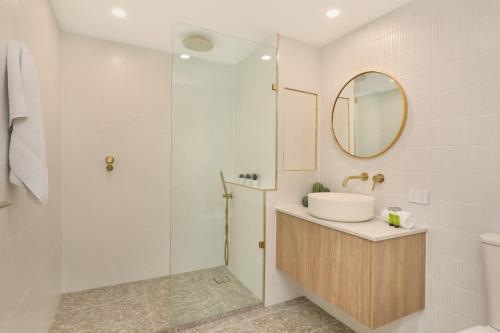 a bathroom with a sink and a shower at Spinnaker Quays in Mooloolaba