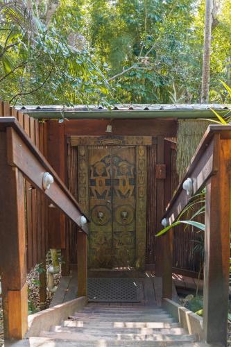 an entrance to a wooden structure with a gate at Garden Burees in Byron Bay