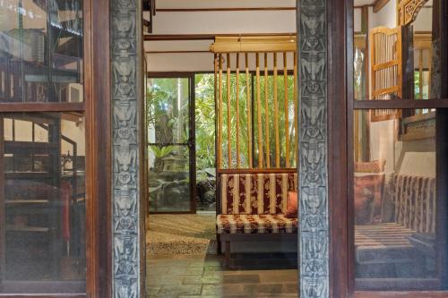 an open door to a porch with a swing at Garden Burees in Byron Bay