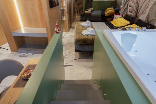a bathroom with a bath tub and a stairway at Ortigia Sitari suites in Siracusa