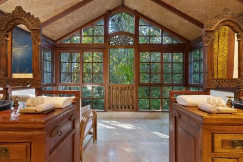 a kitchen with a large window and wooden cabinets at Garden Burees in Byron Bay