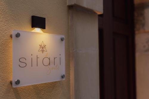 a sign on the side of a building at Ortigia Sitari suites in Siracusa
