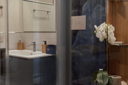 a bathroom with a sink and a mirror at Ortigia Sitari suites in Siracusa