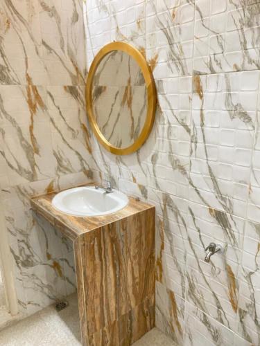 a bathroom with a sink and a mirror on the wall at Djogja Homestay in Piyungan