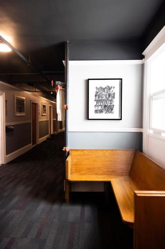 a bench in a room with a picture on the wall at American Hotel in Los Angeles