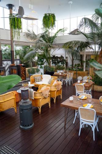 a patio with tables and chairs and a grill at Cottesloe Beach Hotel in Perth