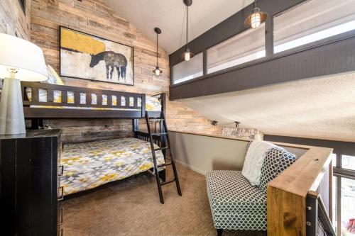 a room with two bunk beds and a desk at Penthouse Condo In The Heart Of The Ski Area! in Steamboat Springs