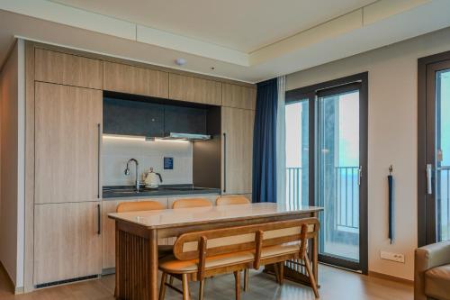 a kitchen with a table and some chairs at More than Sokcho in Sokcho