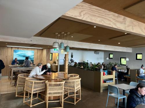 a restaurant with people sitting at tables and a counter at Beach Studio with Ocean View in Gnarabup