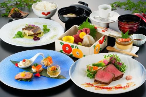a table topped with plates of food on top thereof at Hana Beppu in Beppu