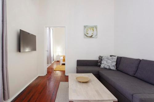 a living room with a couch and a coffee table at Rosa's Place 3 Sth Beach Villa in South Fremantle