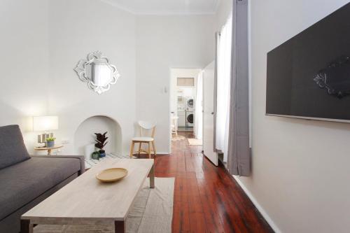 a living room with a couch and a table at Rosa's Place 3 Sth Beach Villa in South Fremantle