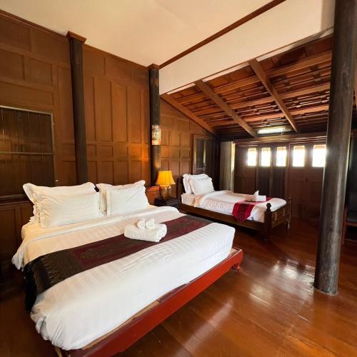 a bedroom with two beds in a room at Sasidara Resort Nan in Nan