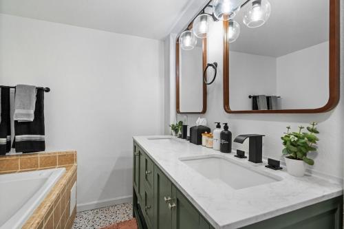 a bathroom with two sinks and a large mirror at Rosequartzplayhouse Wgmrm&more! in Sedona