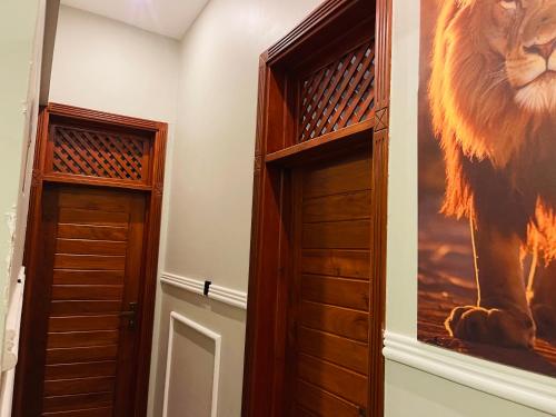 a room with a closet with a lion painting on the wall at Triple s homes in Arusha