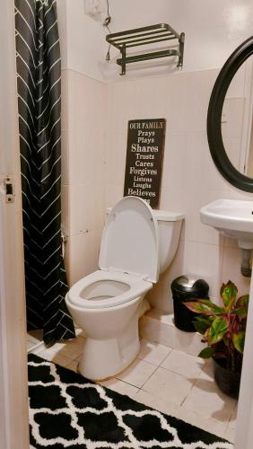 a bathroom with a toilet and a sink at El Nissi Staycation, FAMILY CABIN, CONTEMPORARY CABIN, Enchanted Kingdom in Santa Rosa