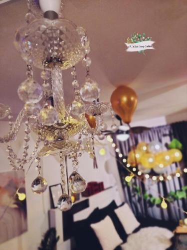 a glass chandelier is hanging from a ceiling at El Nissi Staycation, FAMILY CABIN, CONTEMPORARY CABIN, Enchanted Kingdom in Santa Rosa