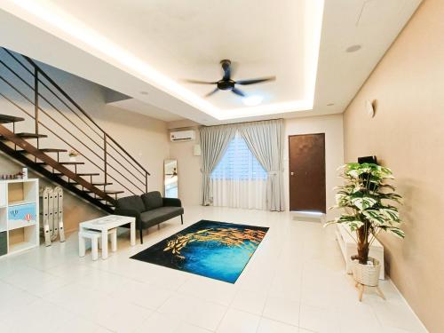 a living room with a couch and a ceiling fan at Zen Clan Homestay Scientex with wifi, aircond, water heater in Pasir Gudang