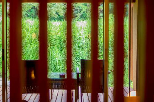 a window with a view of a field of grass at Yamado in Nishiwaga