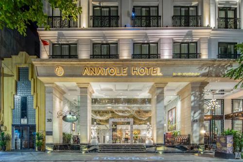 an amedia hotel is shown on a city street at Anatole Hotel Hanoi in Hanoi