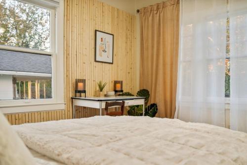 a bedroom with a bed and a desk and a window at Walk To Cherry Street,pets, Hot Tub By Hvnlyhomes in Tulsa