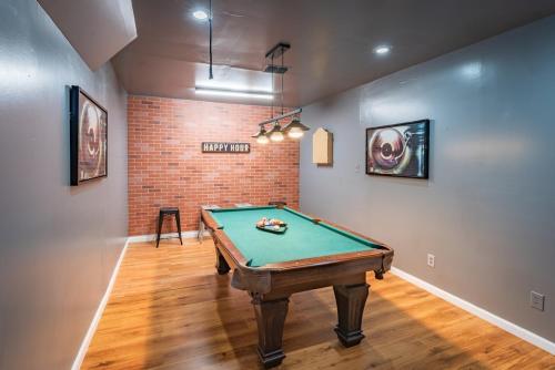 a pool table in a room with a brick wall at Game Room, POOL & Fire pit at the Medical center in San Antonio