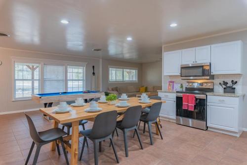 a kitchen with a ping pong table and chairs at Texas Vacation Home, Game Room & Pool By Sixflags in San Antonio