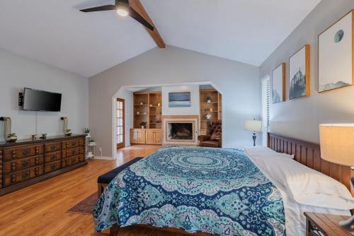 a bedroom with a bed and a fireplace at Beautiful Texas Ranch House, Game Room & Minigolf in San Antonio