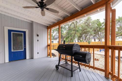a barbecue on a porch with a ceiling fan at Luxury House By Fiesta Texas & Seaworld With Pool in San Antonio