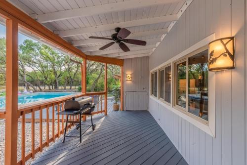 a porch with a ceiling fan and a pool at Luxury House By Fiesta Texas & Seaworld With Pool in San Antonio