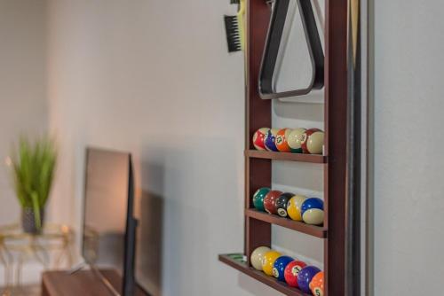 a wooden shelf with balls on it next to a mirror at Stunning Pool Overlooking Golf Course & Game Room in San Antonio