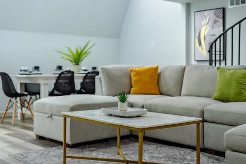 a living room with a couch and a table at Breathtaking Roof Pool Views, Gameroom, Firepit in San Antonio