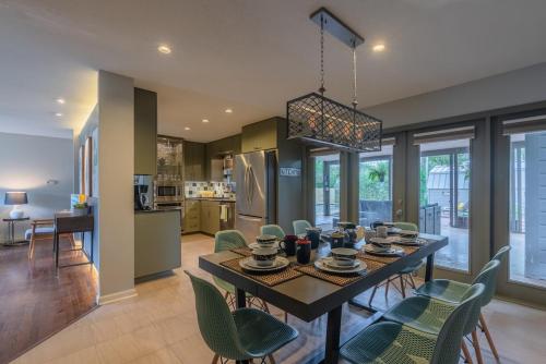 a dining room and kitchen with a table and chairs at Serene POOL & Firepit in Stunning Home By Airport in San Antonio
