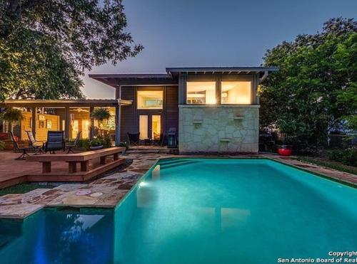 a swimming pool in front of a house at Serene POOL & Firepit in Stunning Home By Airport in San Antonio