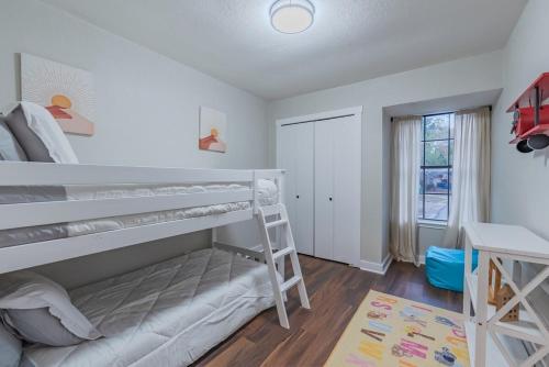 a bedroom with a bunk bed and a window at Stunning Deck, Hot-tub View To Lake & Golf Course in San Antonio