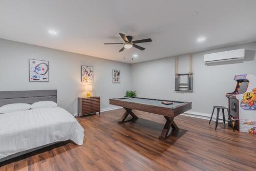 a bedroom with a bed and a pool table at Stunning Deck, Hot-tub View To Lake & Golf Course in San Antonio