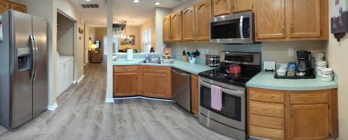 a kitchen with stainless steel appliances and wooden cabinets at Home Away From Home Charlotte in Charlotte
