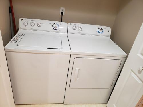 a white washer and dryer in a room at Home Away From Home Charlotte in Charlotte